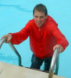 Pull ups on pool ladder with anorak